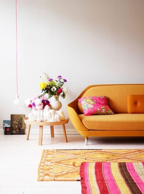 Mod Orange Couch with Funky Rugs